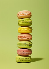 Colourful  macarons on a green background.Minimal creative food concept.Flat lay