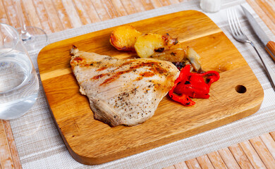 Lunch is beautifully served on plate - fried pork tenderloin, garnished with fried potatoes and...
