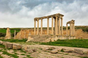 Obraz premium View of historical Temple of Juno Caelestis with columns and ruined stone walls in Dougga, Tunisia