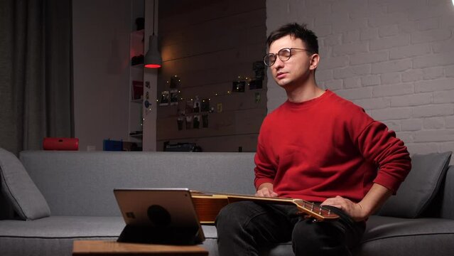 Online lesson. Desperate man. Upset displeased learning online playing guitar 