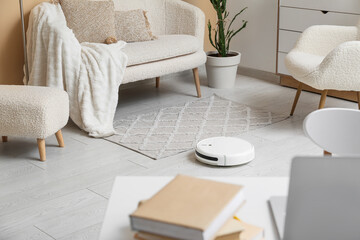 Modern robot vacuum cleaner on floor at home