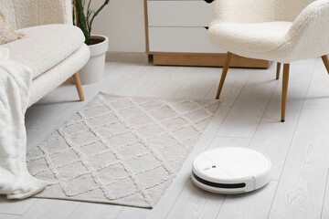 Modern robot vacuum cleaner on floor at home