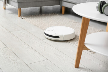 Modern robot vacuum cleaner on floor at home