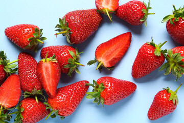 Sweet fresh strawberries on blue background