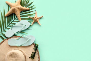 Composition with stylish beach accessories, starfishes and palm leaf on color background