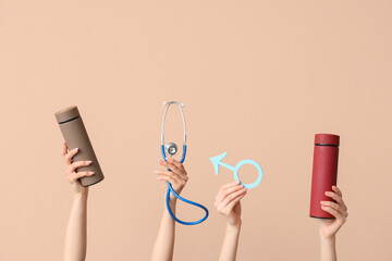 Female hands with water bottles, stethoscope and male sign on beige background. Prostate cancer concept