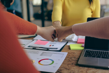 Young business people shaking hands and meeting with documents above to hire a partner or work...