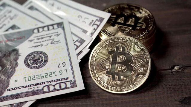 Bitcoin coins with dollar bills on wooden background. Virtual money concept. Digital money concept. Bitcoin mining, online business