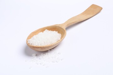Natural salt in wooden spoon on white background