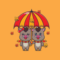 Cute couple boar with umbrella at autumn season