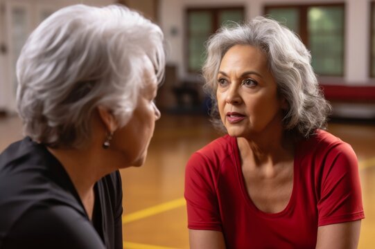senior female coach listening to a client