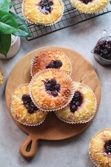 Blueberry streusel sweet bread with fresh berries and creamcheese on a wooden cutting board
