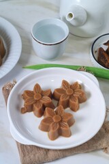 Traditional dessert brown sugar jelly pudding  called agar-agar gula merah on white plate

