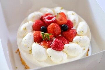 A Japanese-style strawberry shortcake with fresh cream, strawberries, raspberries and blueberries in a white cake box from Maki’s Patisserie in Sydney, Australia