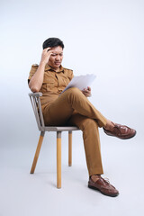 Male Government Worker Checking Paper Work on Gray Studio Background