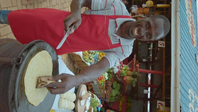 Vertical - Man Frying Chapati At African Market.