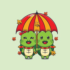 Obraz premium Cute couple turtle with umbrella at autumn season