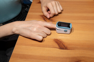 Person Uses Pulse Oximeter Measuring Oxygen Saturation In Blood And Heart Rate. Pulse Oximeter On...