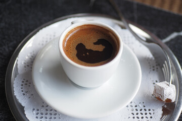 a cup of turkish coffee and a delight on table 