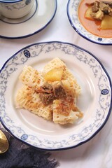 Roti Jala or Lace pancake is Indonesian traditional food served with curry dishes
