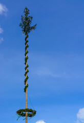 Maypole against blue sky background with copy space