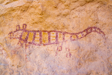 rock art in the Loa river canyon, figure painted in red and yellow, pre-Hispanic art