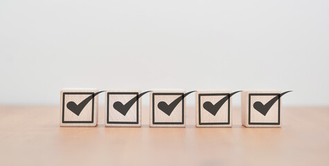 Mark the box on the wooden block on the table. The concept of verification online verification form...