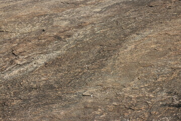 Details of sand stone texture, closeup shot of rock surface with vignette at cover and bright spot at centre, idea for background or backdrop.