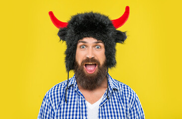 Caucasian amazed guy in bull hat. Surprised man with beard. Brutal man wearing bull hat isolated on...
