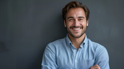 Fototapeta premium Confident Professional: Handsome Smiling Businessman in Blue Shirt isolated on gray background