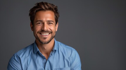 Fototapeta premium Confident Professional: Handsome Smiling Businessman in Blue Shirt isolated on gray background