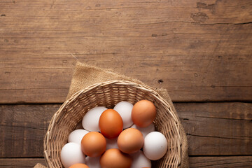 Basket of chicken eggs on a wooden table