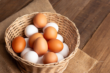 Basket of chicken eggs on a wooden table