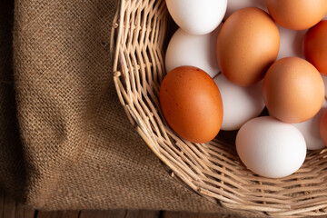 Basket of chicken eggs on a wooden table