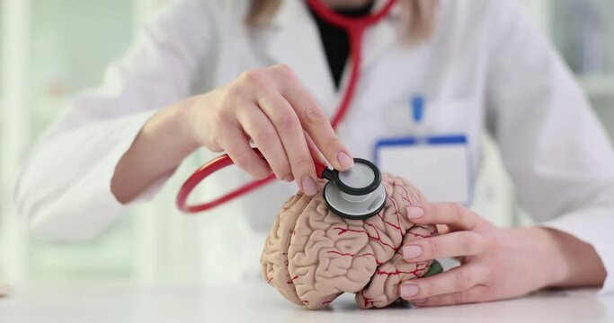 Doctor uses stethoscope on brain model