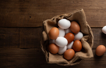 Basket of chicken eggs on a wooden table