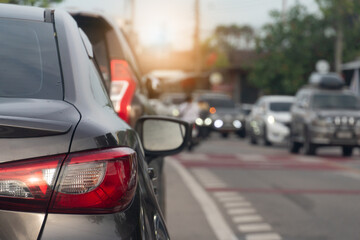 Rear side of brown car. Traffic With many cars on asphalt road and opposit of crossroads road.