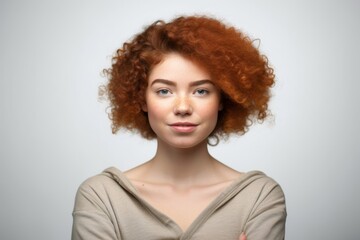confident young woman against white background