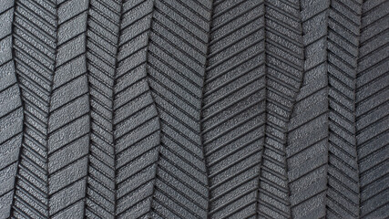 close-up view of sole of shoe pattern, abstract of black rubber textured and grooves surface of bottom of footwear in full frame, macro background or wallpaper for designing