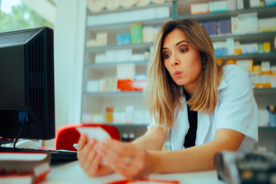 Pharmacist Reading a Prescription Feeling Surprised. Perplexed pharmacy worker trying to figure out the handwriting

