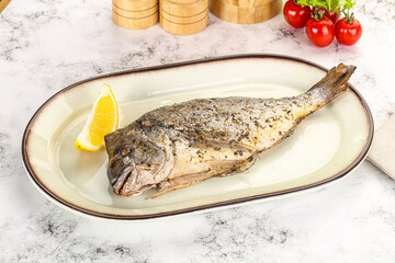 Baked Dorado fish served lemon