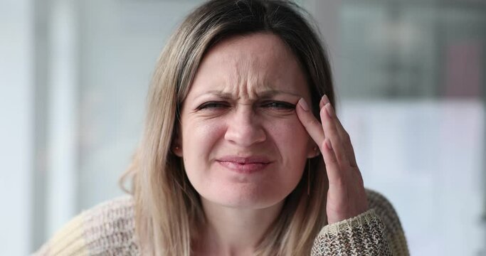Nearsighted woman squints looking into distance