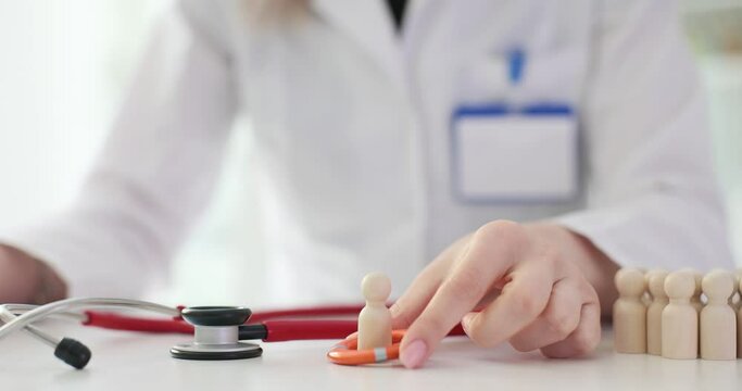 Doctor places lifebuoy on wooden figure