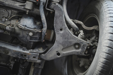 Close-up of car front suspension system components.