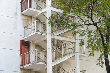 Close-up of reciprocating stairs hanging on the exterior wall of a building in the city