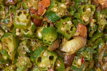 stir fried okra or okro dish close-up, aka lady's fingers, tempered vegetarian curry cooked with...