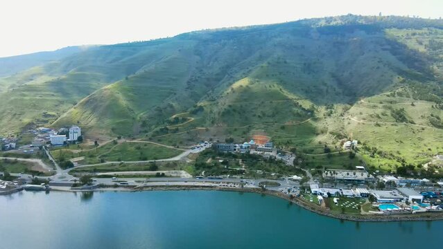 A mountain at the foot of the Sea of Galilee.
Busy road next to the lake. The mountain is shadowed by clouds.
Tomb of Rabbi Meir Baal Hans in the background.