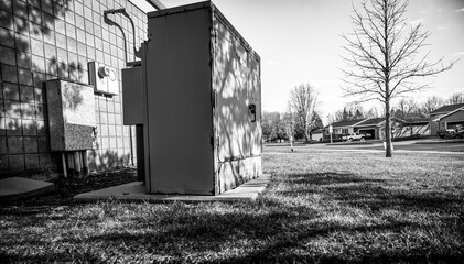 Rusted and peeling paint on an electrical transformer exposed to the elements.