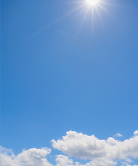 A bright blue sky and a few clouds