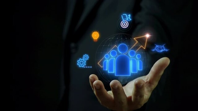 HR human resources solutions concept. Management tool used to manage employee information in organization. Businessman holding magnifying glass to show human resources solution icons on virtual screen